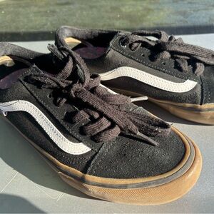 Black vans with brown bottoms.